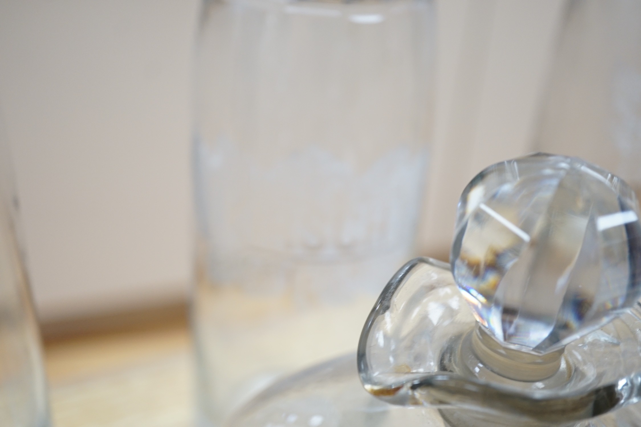 A Victorian cut glass Claret jug and stopper, a step cut pedestal jug, a pair of Dutch decanters, a large Dutch decanter and a set of three etched glass decanters named Kirsch, Cognac & Rhum